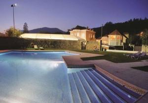a large swimming pool in front of a house at Casón de la Marquesa in Las Fraguas
