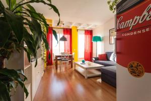 a living room with a couch and a table at Atico Resitur Triana in Seville