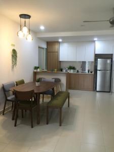 a kitchen and dining room with a table and chairs at Family Friendly Homestay at Setia Alam in Shah Alam