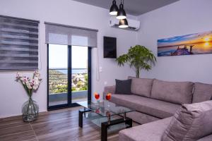 a living room with a couch and a glass table at Maistrali in Rodakino