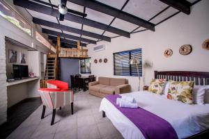 a bedroom with a bed and a living room at Zebrina Guest House in Nelspruit +104 photos