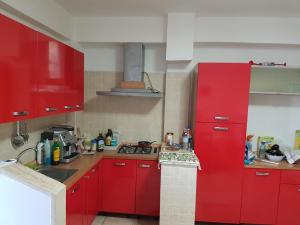 a kitchen with red cabinets and a red refrigerator at Nel Cuore di Campomarino in Campomarino