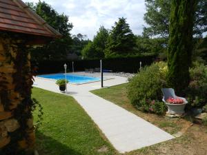 a garden with a swimming pool and a house at La Sembelie in Carsac-Aillac