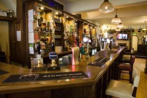a bar with a long counter in a pub at The Kings Head in Louth