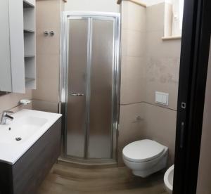 a bathroom with a shower and a toilet and a sink at La Playa Del Sol Tropea in Santa Domenica +60 photos