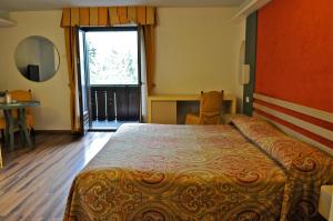 Postel nebo postele na pokoji v ubytování Hotel Baita Clementi