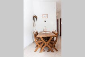 a wooden table and chairs in a room at Apartman 1 in Podstrana