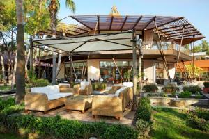 a patio with couches and chairs in front of a building at Martı Myra - Ultra All Inclusive in Tekirova