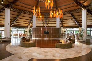 a large lobby with chandeliers and tables and chairs at Martı Myra - Ultra All Inclusive in Tekirova