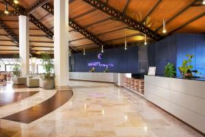 a lobby with blue walls and potted plants at Martı Myra - Ultra All Inclusive in Tekirova