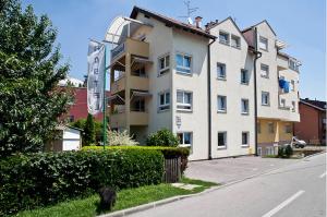 a large white building on the side of a street at Ravnice Rooms and Apartments in Zagreb