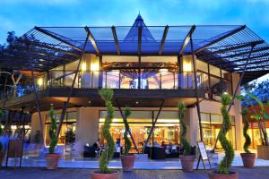 a large building with palm trees in front of it at Martı Myra - Ultra All Inclusive in Tekirova