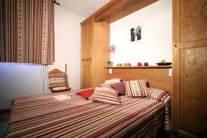 a bedroom with a bed with a red laptop on it at Lagrange Vacances Le Domaine des 100 Lacs in Cauterets +16 photos