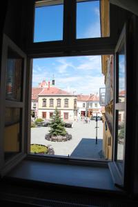 a window view of a courtyard from a building at Portré Apartman in Kőszeg