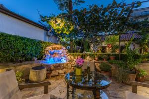 a patio with a table and a stone fireplace at Guesthouse Casa Nova in Poreč