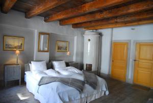 a bedroom with a large bed with white sheets and pillows at Hotel Sven Vintappare in Stockholm