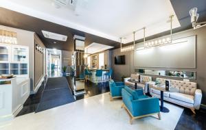 a living room with blue chairs and a table at Frapolli 21 Hotel in Odesa