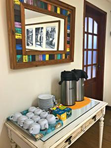 a table with a pot and dishes on it at Palace Hotel in Angra dos Reis