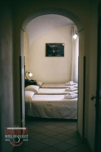 Postel nebo postele na pokoji v ubytování Hotel Risorgimento