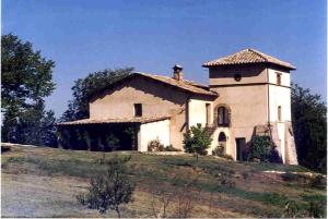 a house on a hill with a tower on it at Agriturismo Monterone in Ponzano Romano