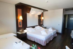 Postel nebo postele na pokoji v ubytování Hotel Cordoba Center