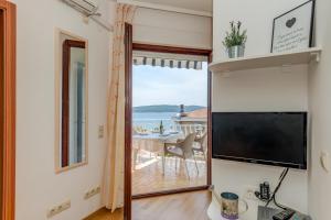 a living room with a large window and a view of the ocean at Villa Daniela in Trogir