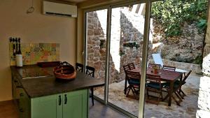 a kitchen and dining area with a table and a dining room at Villa Cherie in Sutomišćica