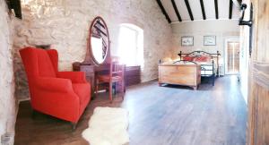 a living room with a red chair and a mirror at Villa Cherie in Sutomišćica +51 photos