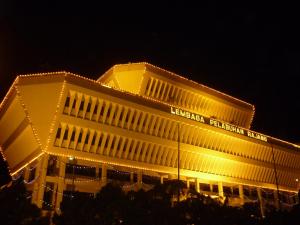 un bâtiment éclairé la nuit avec des lumières jaunes dans l'établissement H Homestay Sibu - 500Mbps Wifi, Full Astro & Private Parking!, à Sibu