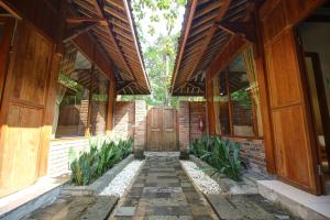 an entrance to a brick building with a wooden door at Cempaka Villa II in Borobudur