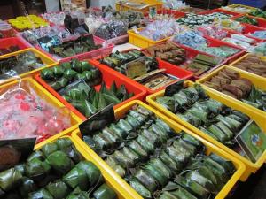 a display of vegetables in yellow bins at a market at Homestay Bukit Katil Melaka 10Pax 3R3B in Malacca
