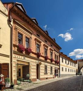 a building with flower boxes on the side of a street at Pension Rozmarýna in Český Krumlov