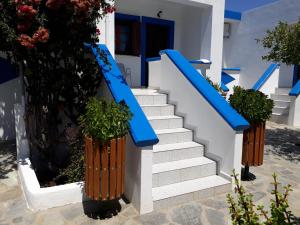 a set of stairs with blue rails and plants at Paradise Studios in Lipsoi