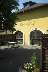 a restaurant with a table and chairs in front of a building at Remserhof in Sankt Valentin
