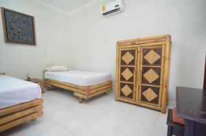 Postel nebo postele na pokoji v ubytování Puri Itoma Bungalows