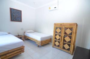 Postel nebo postele na pokoji v ubytování Puri Itoma Bungalows