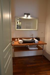 a bathroom with a sink and a mirror at La Gentilhommière in Chantepie