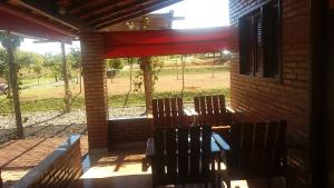 a group of chairs sitting on a patio at Chales Recanto das Seriemas in São Roque de Minas