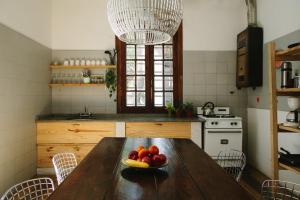 a kitchen with a wooden table with a bowl of fruit on it at Casa Helsinki in Cordoba