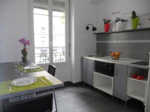 a kitchen with a sink and a table with a plate at au 303 in Lyon