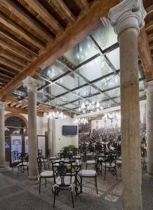 a large room with tables and chairs in a building at Posada Real Los Cinco Linajes in Arévalo