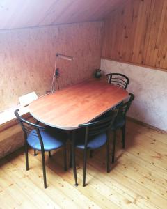 a table with chairs and a lamp on top of it at Jolando Apartment in Kaunas