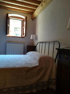 a bed in a bedroom with a window and a bed sidx sidx sidx at Casa Maria Teresa in San Donato in Poggio