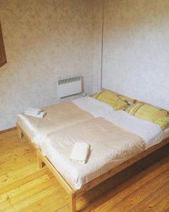 a bed with two towels on it in a room at Jolando Apartment in Kaunas