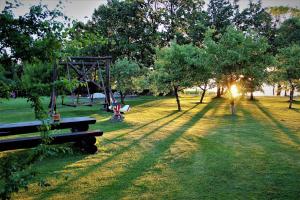 a person walking in a park with a park bench at Kalda Camping Valma in Valma