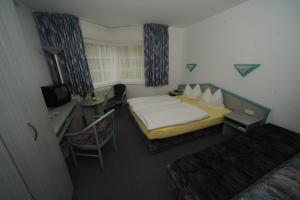 Postel nebo postele na pokoji v ubytování Hotel Am Markt