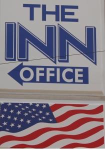 a sign for the us office with an american flag at The Inn in El Dorado
