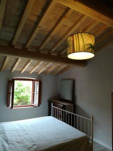 a bedroom with a bed and a window and a lamp at Casa Maria Teresa in San Donato in Poggio