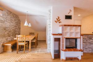 a kitchen and dining room with a table and a fireplace at Apartment Ledrar in Bled