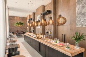 a restaurant with a counter with food on it at Intercity Porto Alegre Cidade Baixa in Porto Alegre +32 photos